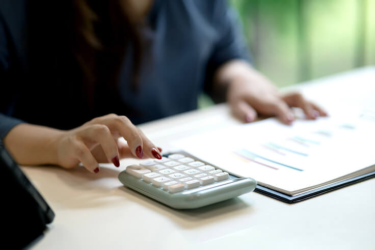 Female with calculator and folder with chart